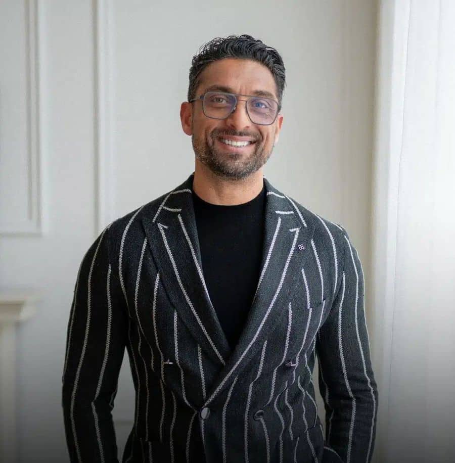 Portrait of Zarak Fatah smiling in a striped blazer
